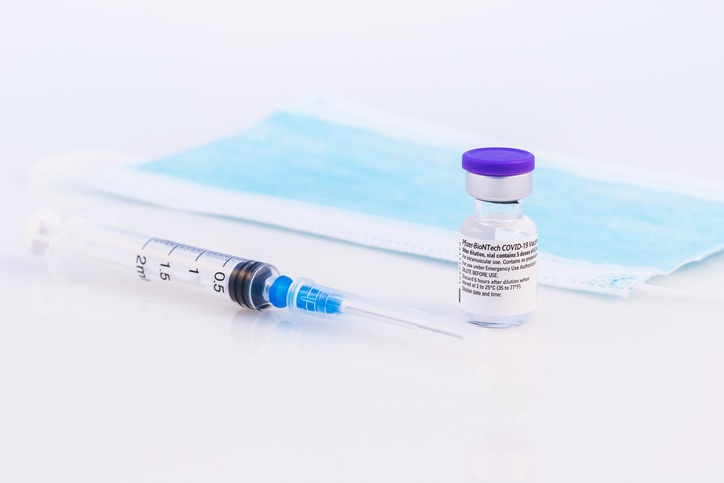 Pfizer vax, syringe and mask