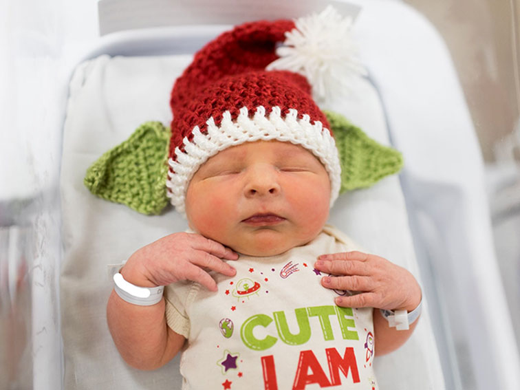 Baby in Santa hat with Yoda ears