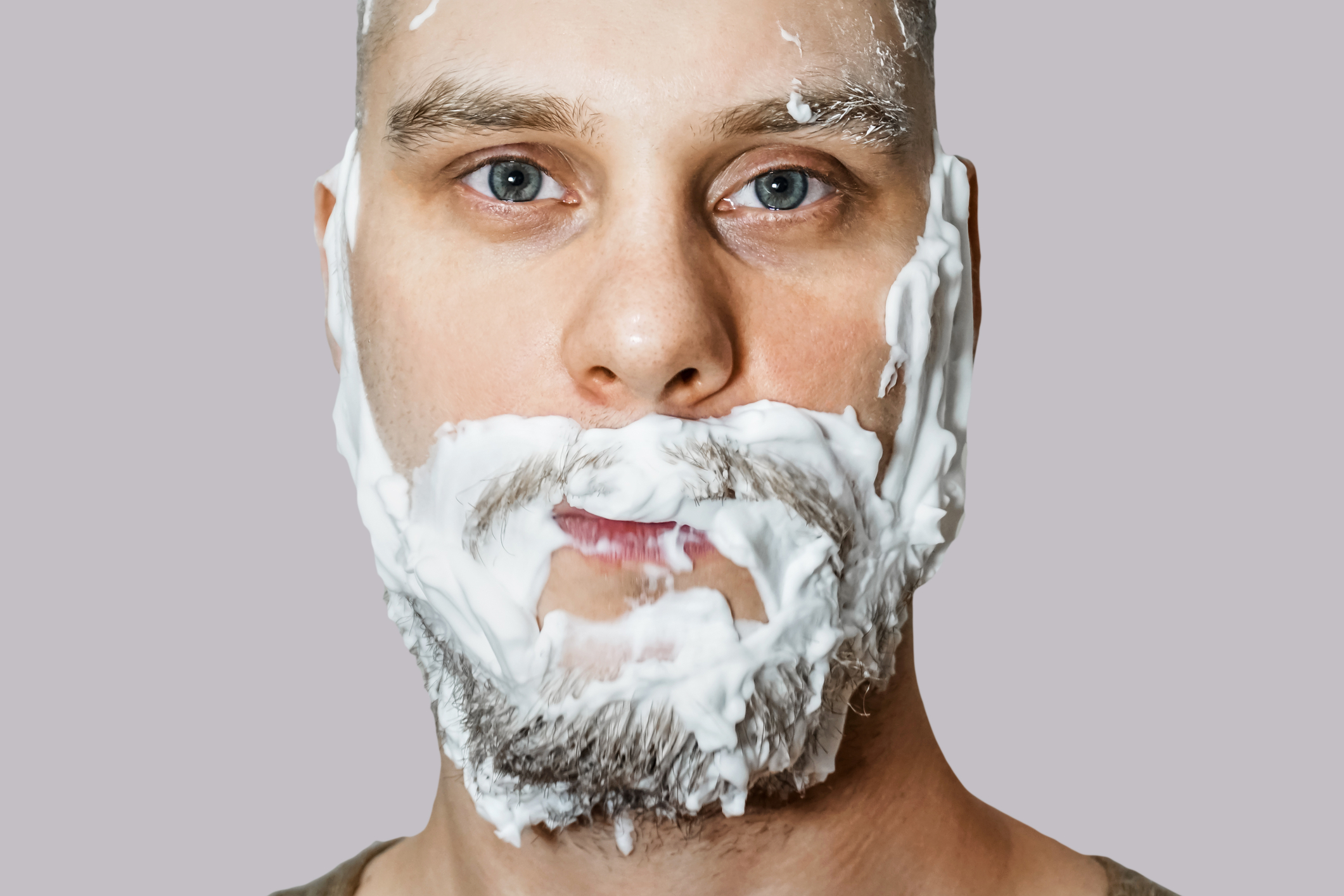 Man with beard covered in shaving cream