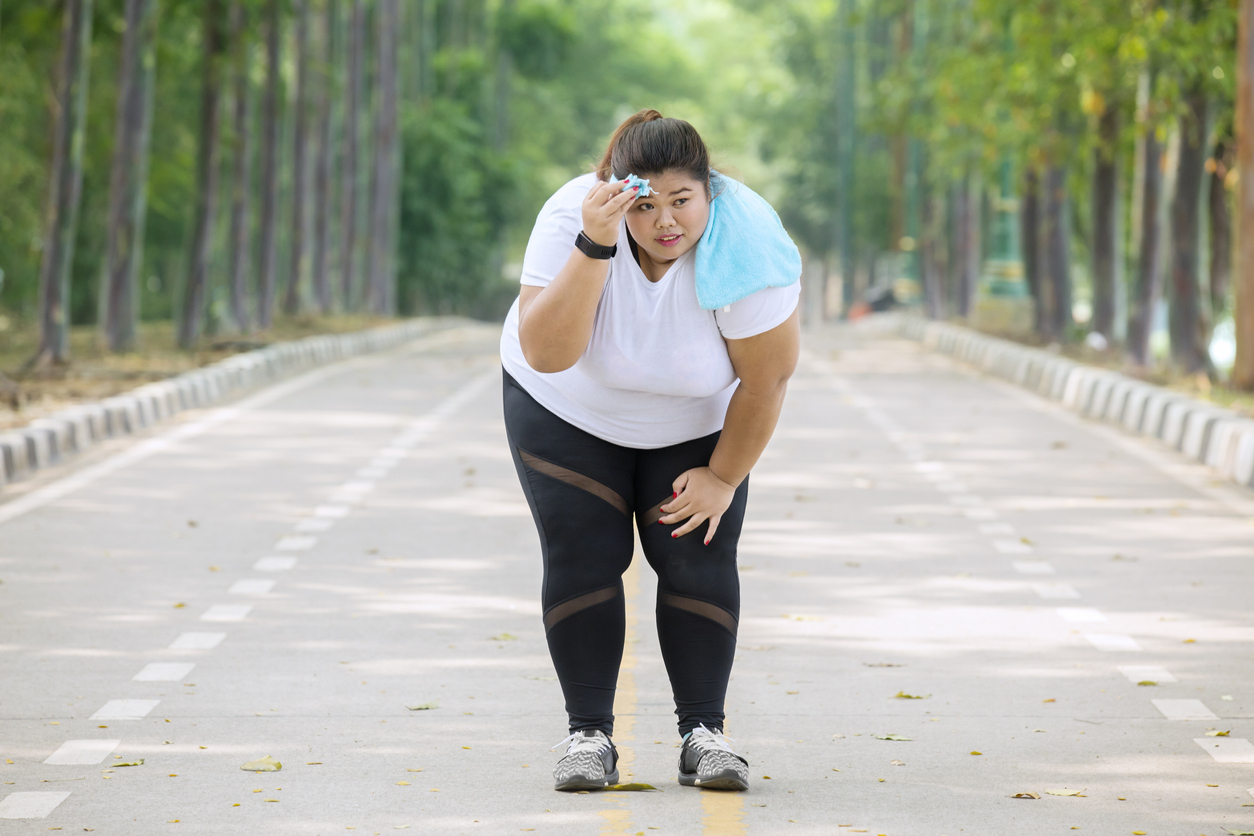Obese woman bent over with breathlessness