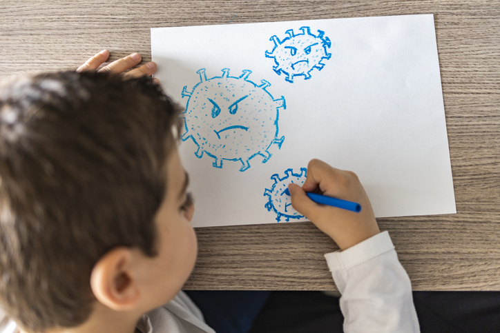boy drawing nasty-looking coronaviruses