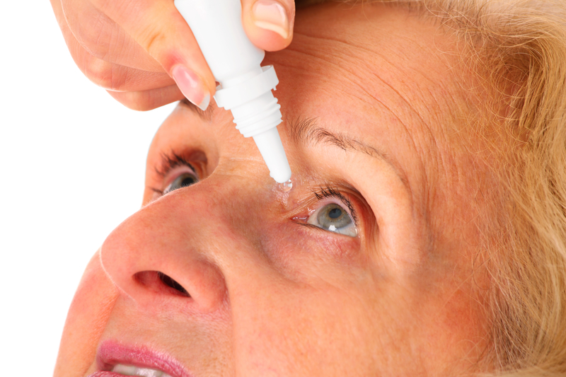 Senior woman using eye drops