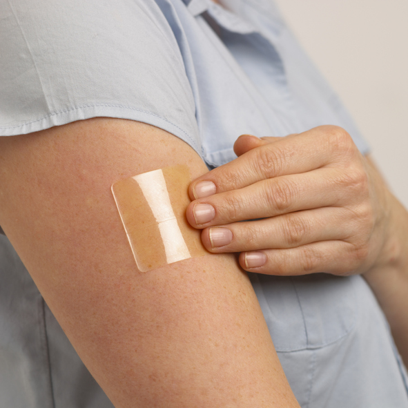 Woman with nicotine patch on her arm
