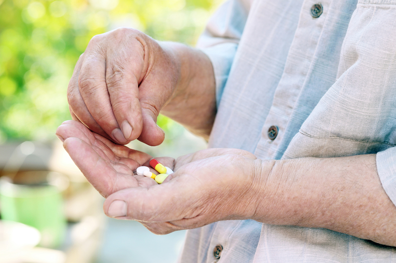Woman aged over 65 holding pills