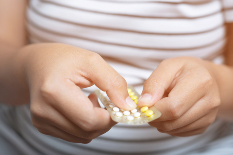 woman taking oral contraceptive pill