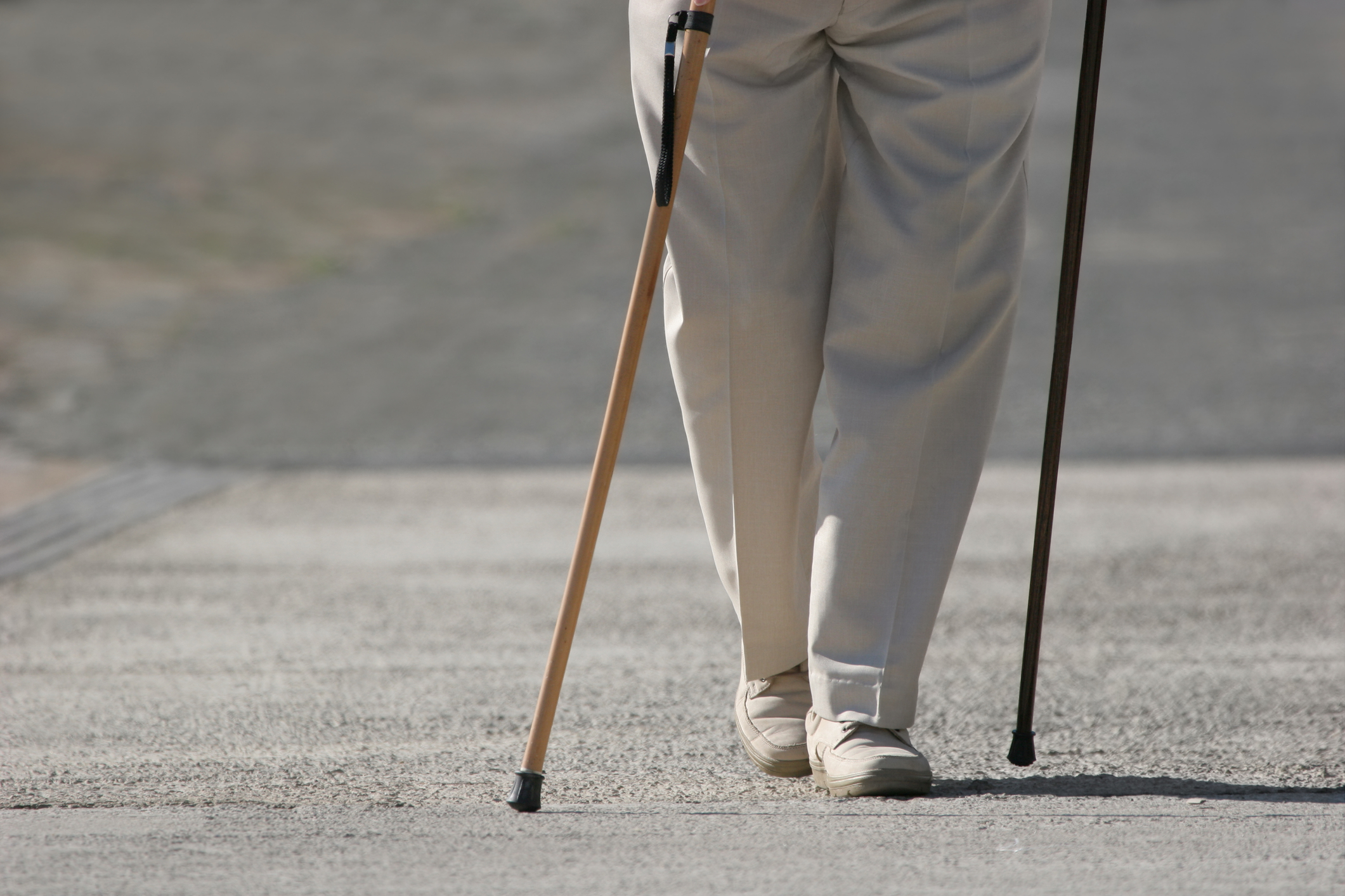 senior man walking with 2 canes