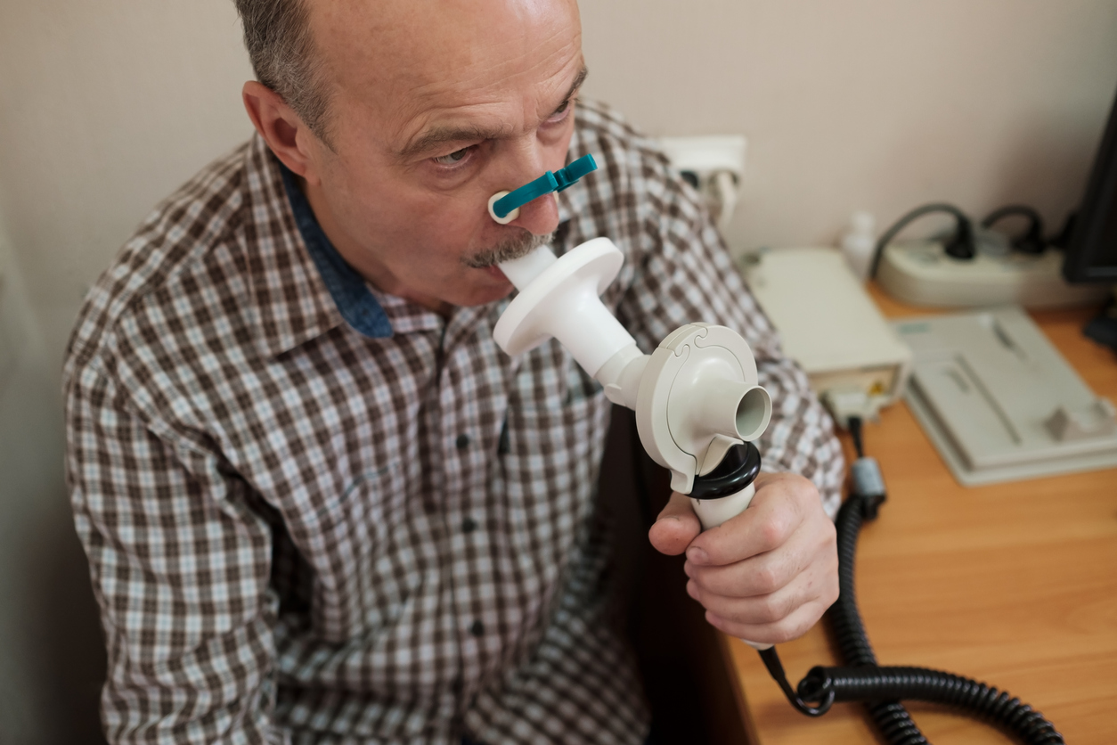 senior man doing spirometry
