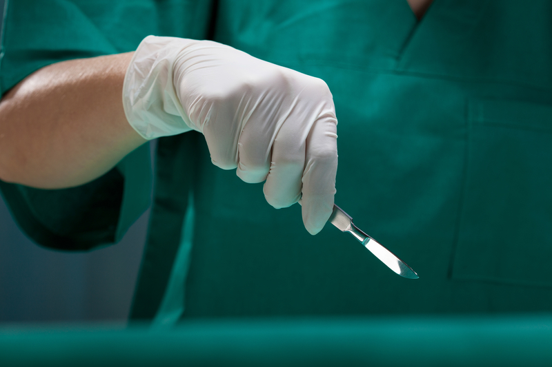 Surgeon's hand holding a scalpel