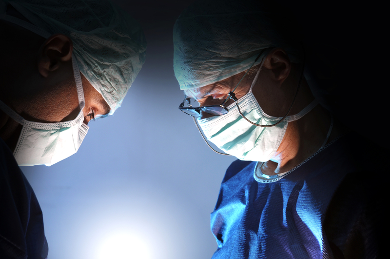 two surgeons in masks concentrating during an operation