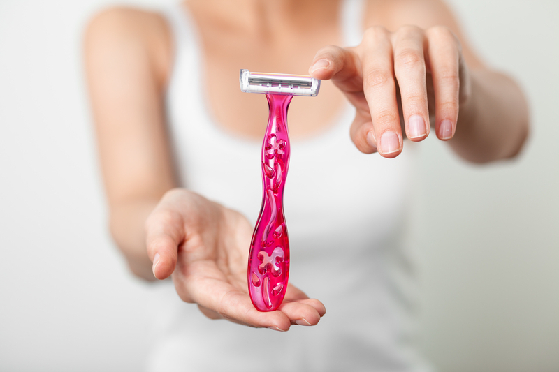 Woman holding pink razor