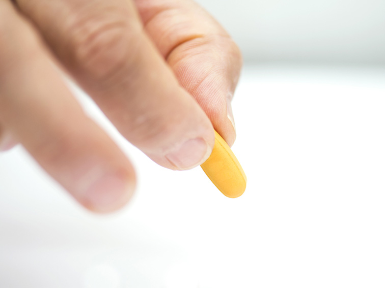 person holding yellow pill - PPI